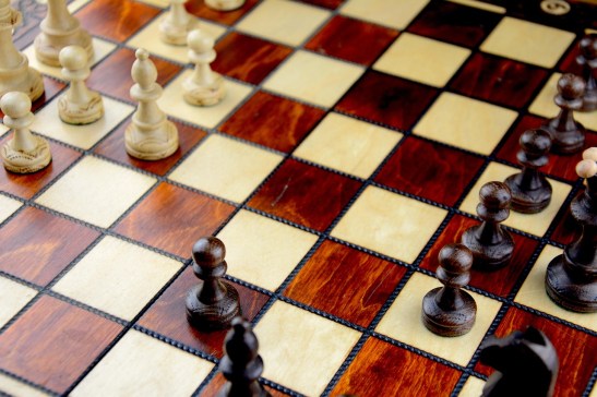 close up photo of a red and beige chessboard